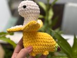 The baby holds the rex bananasaurus crochet 2