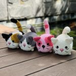 Four crocheted loaf cats.